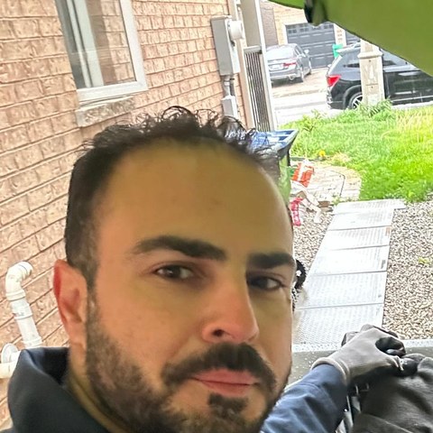 Mostafa, HVAC technician at Kohan R&R, working on a condenser unit