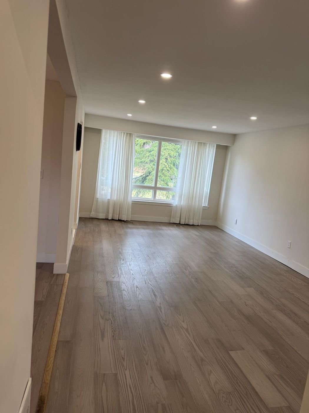 Living space with recessed pot lights installed throughout the ceiling